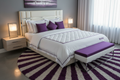 Purple Restore Soft Queen Mattress with purple and white luxury bedding in a modern bedroom